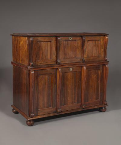 A LARGE FINELY FIGURED ROSEWOOD COLLECTOR S CABINET OF UNUSUAL FORM