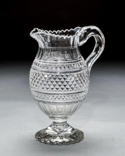 A LARGE PEDESTAL WATER JUG