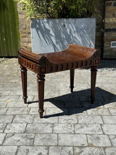 A LATE REGENCY PERIOD CARVED MAHOGANY HALL STOOL CARVED BY RICHARD PENN