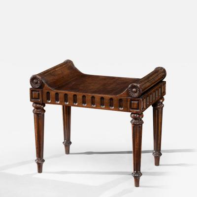 A LATE REGENCY PERIOD CARVED MAHOGANY HALL STOOL CARVED BY RICHARD PENN