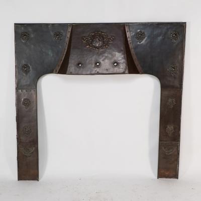 A Large Arts Crafts Copper Fire Insert with a Lion in a Shield Crest