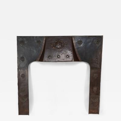 A Large Arts Crafts Copper Fire Insert with a Lion in a Shield Crest