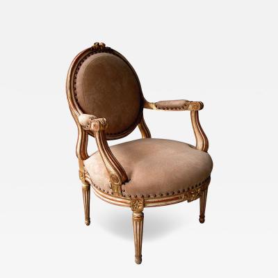 A Large scaled French Louis XVI Style Ivory Painted and Parcel Gilt Armchair
