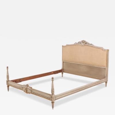 A Louis XVI style painted and gilt carved wood bed C 1930 