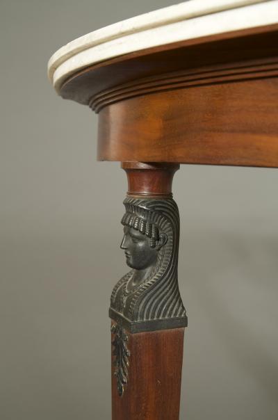 A MAHOGANY AND FAUX BRONZE DEMILUNE PIER TABLE IN THE RETOUR D EGYPT TASTE