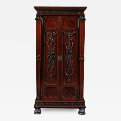 A MAHOGANY TWO DOOR CABINET SET WITH CARVED GOLFING TROPHIES 