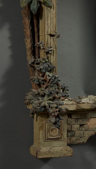 A MOST UNUSUAL FINELY CARVED AND NATURALISTICALLY PAINTED MIRROR