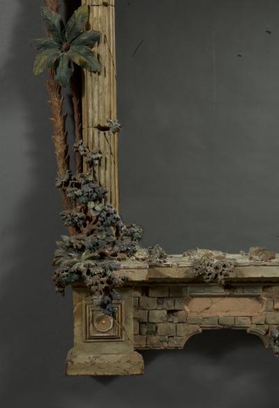 A MOST UNUSUAL FINELY CARVED AND NATURALISTICALLY PAINTED MIRROR