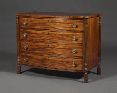 A Mahogany Bow Fronted Commode with Unusual Reeded Column Corner Posts and Feet