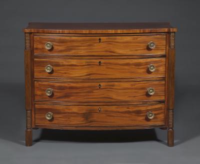 A Mahogany Bow Fronted Commode with Unusual Reeded Column Corner Posts and Feet