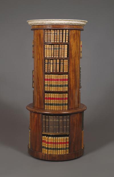 A Mahogany Circular Bookcase With A Statuary Dished Marble Top
