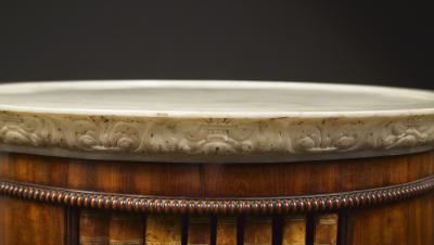 A Mahogany Circular Bookcase With A Statuary Dished Marble Top