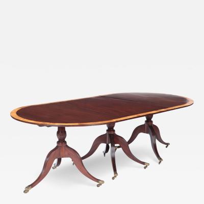 A Mahogany triple pedestal dining table with banded top England circa 1910 