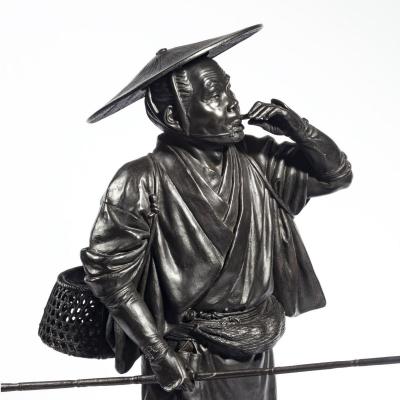 A Meiji period bronze of a cricket catcher