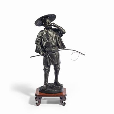 A Meiji period bronze of a cricket catcher