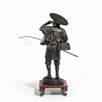 A Meiji period bronze of a cricket catcher