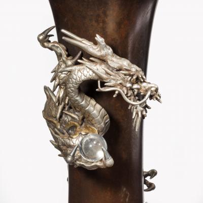 A Meiji period bronze trumpet vase with a dragon