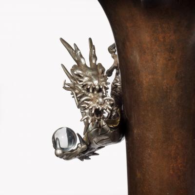 A Meiji period bronze trumpet vase with a dragon