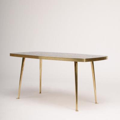 A Mid Century German coffee table with a mosaic top on brass metal legs