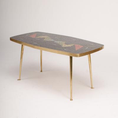 A Mid Century German coffee table with a mosaic top on brass metal legs