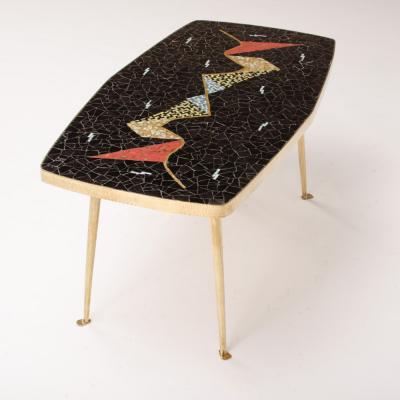A Mid Century German coffee table with a mosaic top on brass metal legs