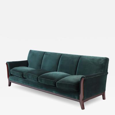 A Mid Century Modern French large sofa with green velvet upholstery circa 1945 