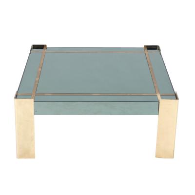 A Mid Century Modern coffee table with brass legs and trim Circa 1970