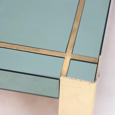 A Mid Century Modern coffee table with brass legs and trim Circa 1970