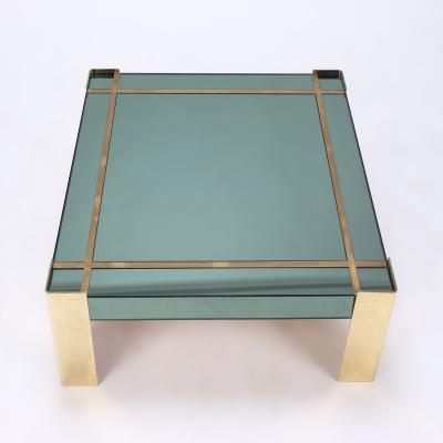 A Mid Century Modern coffee table with brass legs and trim Circa 1970