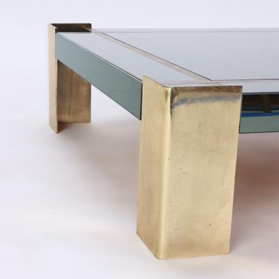 A Mid Century Modern coffee table with brass legs and trim Circa 1970