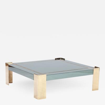A Mid Century Modern coffee table with brass legs and trim Circa 1970