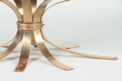 A Mid Century Modern oval bronze coffee table with a glass top France C 1960