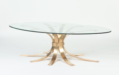 A Mid Century Modern oval bronze coffee table with a glass top France C 1960