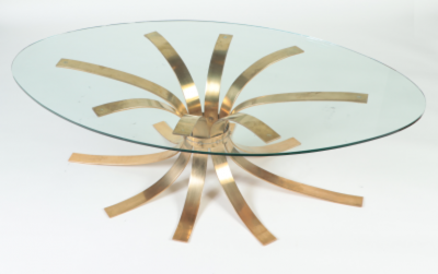 A Mid Century Modern oval bronze coffee table with a glass top France C 1960