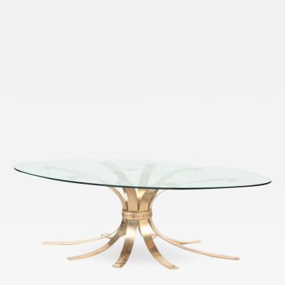 A Mid Century Modern oval bronze coffee table with a glass top France C 1960