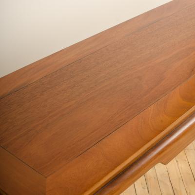 A Mid Century mahogany console in the manner of J Mont circa 1950 