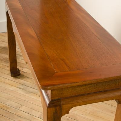 A Mid Century mahogany console in the manner of J Mont circa 1950 