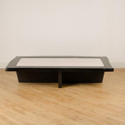 A Modernist rectangular coffee table with eggshell fragment top Contemporary
