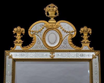 A NEAR PAIR OF VICTORIAN PERIOD ORMOLU MOUNTED ENGRAVED MIRRORS