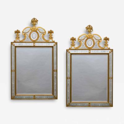 A NEAR PAIR OF VICTORIAN PERIOD ORMOLU MOUNTED ENGRAVED MIRRORS