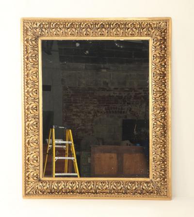 A Nineteenth Century continental relief and gilt carved mirror 