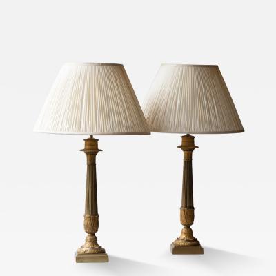 A PAIR OF 19TH CENTURY GILT CANDELABRA CONVERTED TO LAMPS