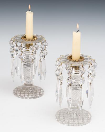 A PAIR OF ANTIQUE REGENCY CUT GLASS CANDLESTICKS