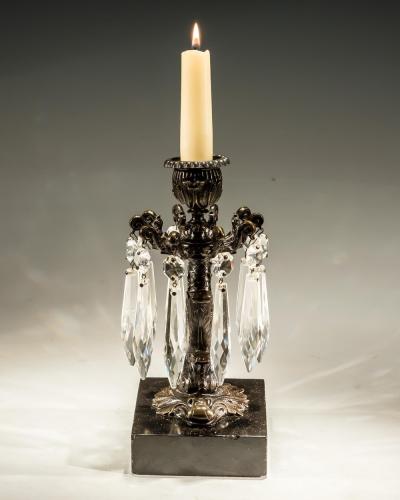 A PAIR OF BRONZED DOLPHIN CANDLESTICKS