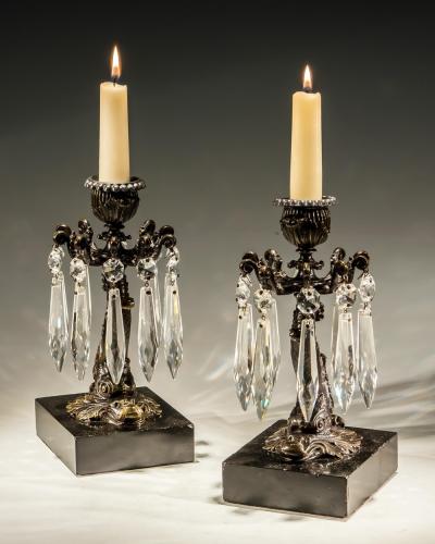 A PAIR OF BRONZED DOLPHIN CANDLESTICKS