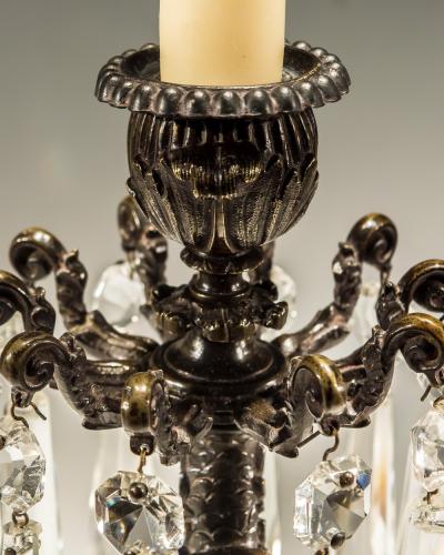 A PAIR OF BRONZED DOLPHIN CANDLESTICKS