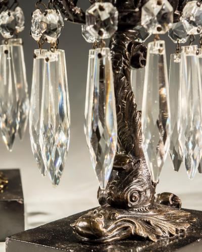 A PAIR OF BRONZED DOLPHIN CANDLESTICKS