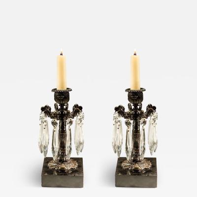 A PAIR OF BRONZED DOLPHIN CANDLESTICKS