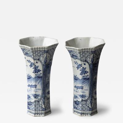 A PAIR OF DUTCH DELFT GADROONED OCTAGONAL BLUE AND WHITE BEAKER VASES