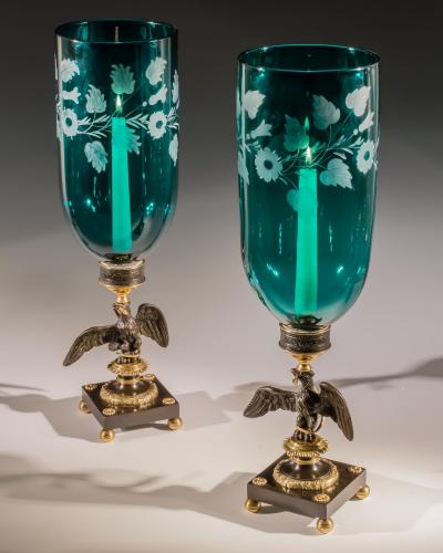 A PAIR OF ENGRAVED GREEN STORM SHADES ON EAGLE BASES
